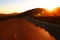 The road in the light of the autumn sunset on the Plateau of the Bucegi mountains, Romania, Europe.