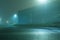 A road and light industrial units, on a foggy, spooky, atmospheric winters night