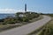 Road, lighthouse and the sea