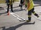 Road marking. Drawing a road marking. spraying in road construction. Worker draws a white line on the surface of the street