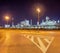 Road markings with illuminated oil refinery on the background