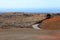 Road in martian landscape of solidified lava in National Park of Timanfaya, Lanzarote volcanic island