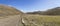 Road in mild green slopes at Campo Imperatore upland, Abruzzo, Italy