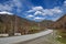 Road mountains clouds curve asphalt