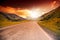 Road in the mountains landscape with bright sunset