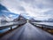 Road and mountains in the night, Lofoten islands, Norway. Asphalt and moonlight. Winter landscape with night sky. Long exposure sh