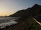 Road, mountains and the sea during sunset