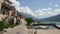 The road near the sea. Embankment street in the city of Dobrota, Montenegro. Ancient stone house with a staircase from