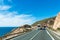 Road next to the sea and a truck with a refrigerated semi-trailer