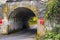 Road through an old one-way arched concrete bridge