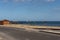 Road with old pedestrian crossing towards a golden manmade sand beach near the Atlantic, San Blas, Tenerife, Canary Islands