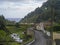 Road in old small village Faial da Terra with cascading river and sea horizon, Sao Miguel, Azores