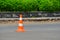 Road orange conical sign on the repair of the road in the city