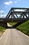 Road that passes under a railway bridge on a clear day in spring in the italian countryside