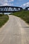 Road that passes under a railway bridge on a clear day in spring in the italian countryside