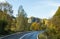 The road passing at the foot of the Carpathian Mountains near the town of Bran in Romania