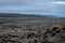 The road passing through a lava field, frozen with waves and overgrown with silvery moss and stretches to the horizon
