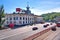 The road passing near the ancient building of the Kiev river station on a background of green trees. Kiev, Ukraine