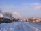 road past fences in the village of Siberia tram on rails in winter in the snow