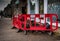 Road pavement excavation work area with red safety barriers