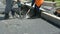 Road Paving. Workers laying stone mastic asphalt during street repairing works.