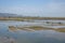 A road piled up on saline alkali land, a salt pond