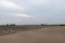 A road piled up on saline alkali land, a salt pond