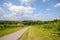 Road with a pinwheel Klapotetz through the vineyard, Southern Styria Austria