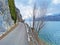 Road and promenade along the subalpine Lake Walen or Lake Walenstadt Walensee and the cliffs at the foot of the Churfirsten