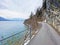 Road and promenade along the subalpine Lake Walen or Lake Walenstadt Walensee and the cliffs at the foot of the Churfirsten