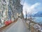 Road and promenade along the subalpine Lake Walen or Lake Walenstadt Walensee and the cliffs at the foot of the Churfirsten