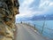 Road and promenade along the subalpine Lake Walen or Lake Walenstadt Walensee and the cliffs at the foot of the Churfirsten