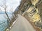 Road and promenade along the subalpine Lake Walen or Lake Walenstadt Walensee and the cliffs at the foot of the Churfirsten