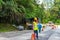 Road repair in Asia. Fenced road section with a pit. Workers overalls