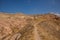 The road in the rocks in the Rose valley, Gulludere valley. In the distance White mountain, Aktepe hill. Cappadocia, Anatolia,