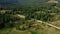 Road in rocky forest aerial view warm sunny summer day green spruces background