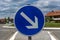 Road round blue arrow sign. close up. blue sky