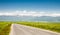 Road running through the countryside overlooking snow-capped mountains