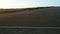 Road running through rural fields at dawn. Shot. Top view of beautiful rural landscape of dark farm fields at dawn. Top
