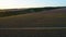 Road running through rural fields at dawn. Shot. Top view of beautiful rural landscape of dark farm fields at dawn. Top