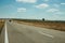 Road through rural landscape and car near the Monfrague National Park