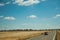 Road through rural landscape and car near the Monfrague National Park