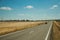 Road through rural landscape and car near the Monfrague National Park