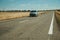 Road through rural landscape and car near the Monfrague National Park