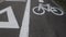 Road section with road markings regulating the movement of cyclists. Bicycle signs on the road. Bicycle road with arrow