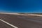 On the road side of the Stuart highway. Along the deserted barren vast landscape of the Australian outback. The grey red asphalt