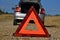 Road side warning triangle behind a car