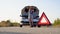 Road side warning triangle, warning oncoming traffic of a broken down car, with a woman using her cell phone to call for