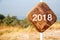 Road sign with 2018 on wooden background represents the new 2018.New Year 2018 wooden banner