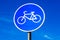 Road sign for bikes lane against the sky